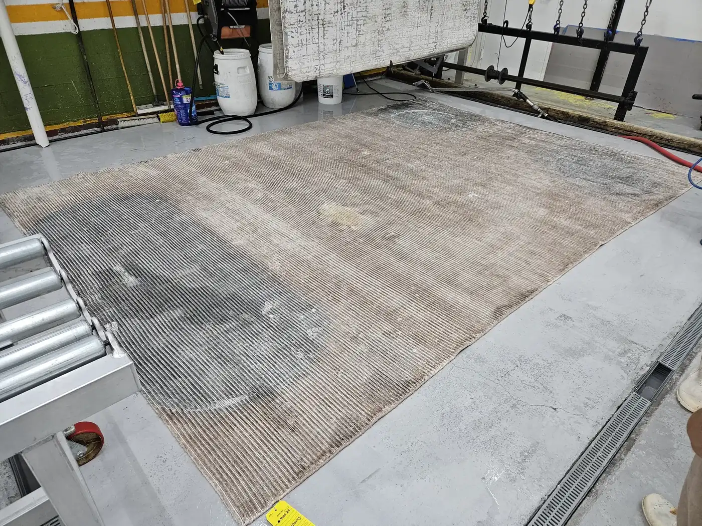 Rug spread flat across the wash floor for a full wet wash